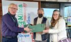 Dave and Liz from Budding Engineers handing a box of laptops to Robert Gill, headteacher of Milton of Leys Primary School in Inverness. Supplied by High Life Highland Date