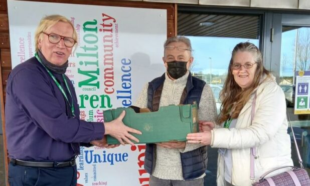 Dave and Liz from Budding Engineers handing a box of laptops to Robert Gill, headteacher of Milton of Leys Primary School in Inverness. Supplied by High Life Highland Date
