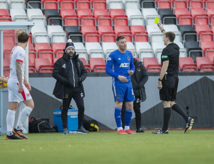 Cove Rangers manager Paul Hartley watches on as Rory McAllister is booked. Photo by Dave Cowe