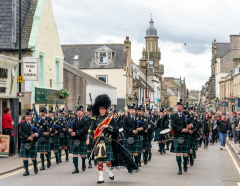 Forres and District Pipe Band march down the High Street of Forres to Grant Park for the games in 2019.