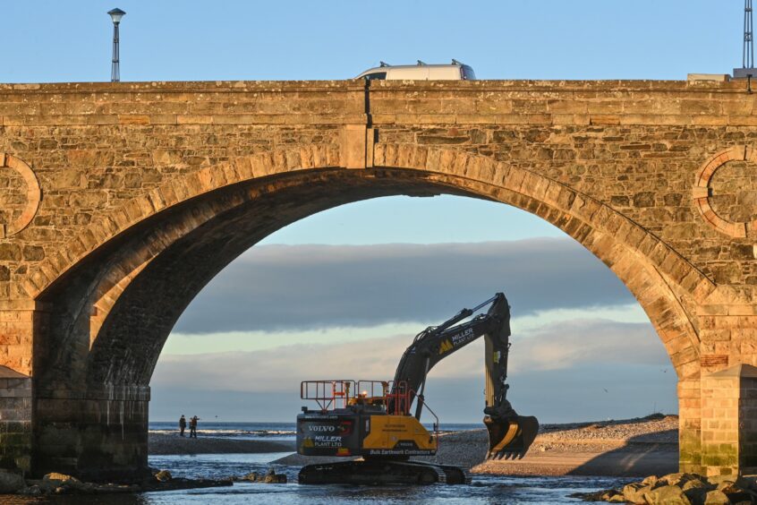 Banff Bridge with a digger working between the arches