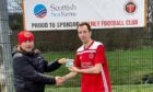 Orkney man of the match Chris Simpson with Richard Darbyshire from sponsors Scottish Sea Farms.