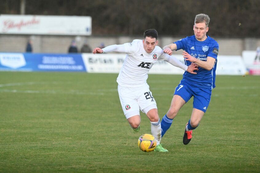 Cove Rangers midfielder Robbie Leitch holds off his Peterhead counterpart Hamish Ritchie