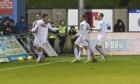 Rory McAllister, left, wheels away in celebration ahead of his Cove Rangers team-mates