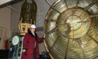 Lynda McGuigan is pictured with the Isle of May Lighthouse Lens, which will need to be dismantled and moved before repairs begin.