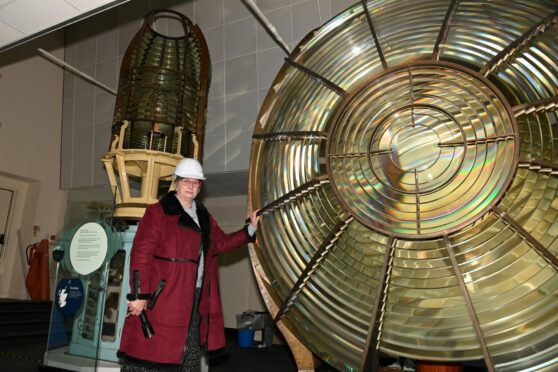 Lynda McGuigan is pictured with the Isle of May Lighthouse Lens, which will need to be dismantled and moved before repairs begin.