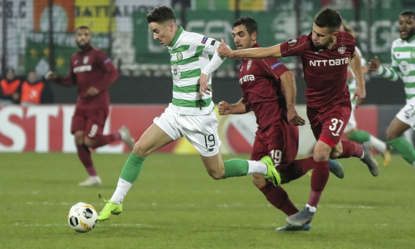 Celtic's Mikey Johnston, left, challenges for the ball with Cluj's Mihai Bordeianu, left, during a Europa League match.
