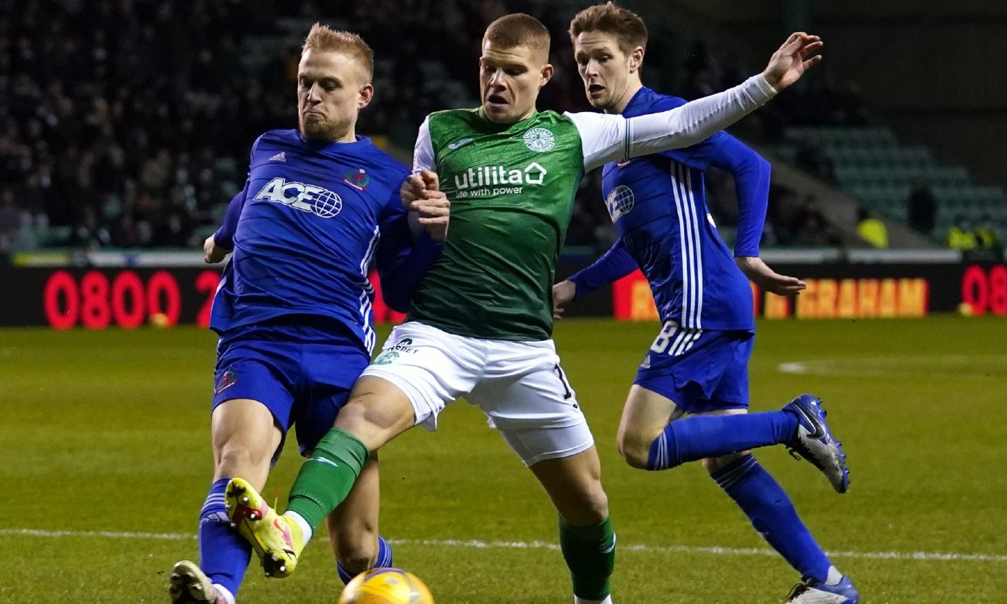 Cove Rangers defender Harry Milne moves in to block Chris Mueller