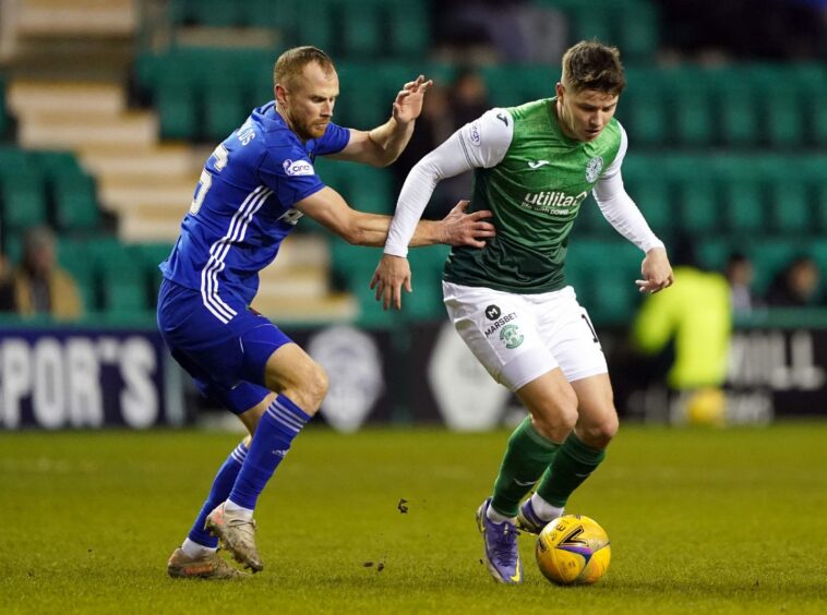 Cove Rangers defender Mark Reynolds (left) and Hibernian's Kevin Nisbet battle