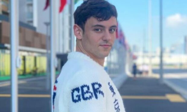 Diver Tom Daley in a Team GB cardigan he knitted himself.