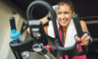 Girl working out in her home gym. (Image of the article about how to set up a home gym)