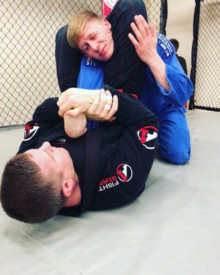 Craig Guthrie and Calum Dalrymple wrestling each other on the ground during jiu-jitsu session