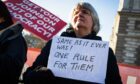Protesters demonstrate against prime minister Boris Johnson and the 'partygate' scandal outside parliament in London