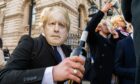 A group of men dressed as Boris Johnson stage a mock lockdown party protest outside Downing Street (Photo: Amer Ghazzal/Shutterstock)