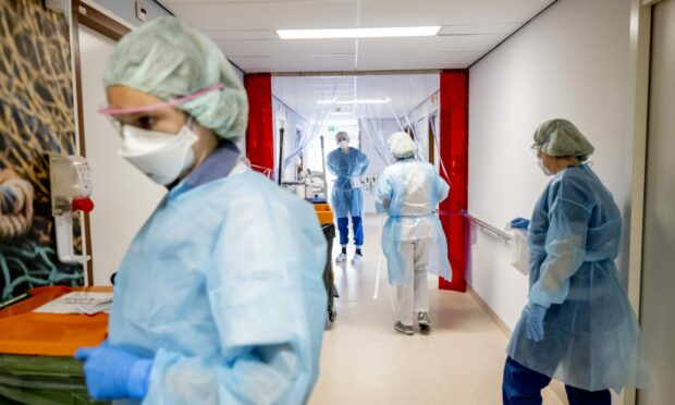 Nurses treat a Covid patients on the ICU Ward. Photo by Robin Utrecht/Shutterstock