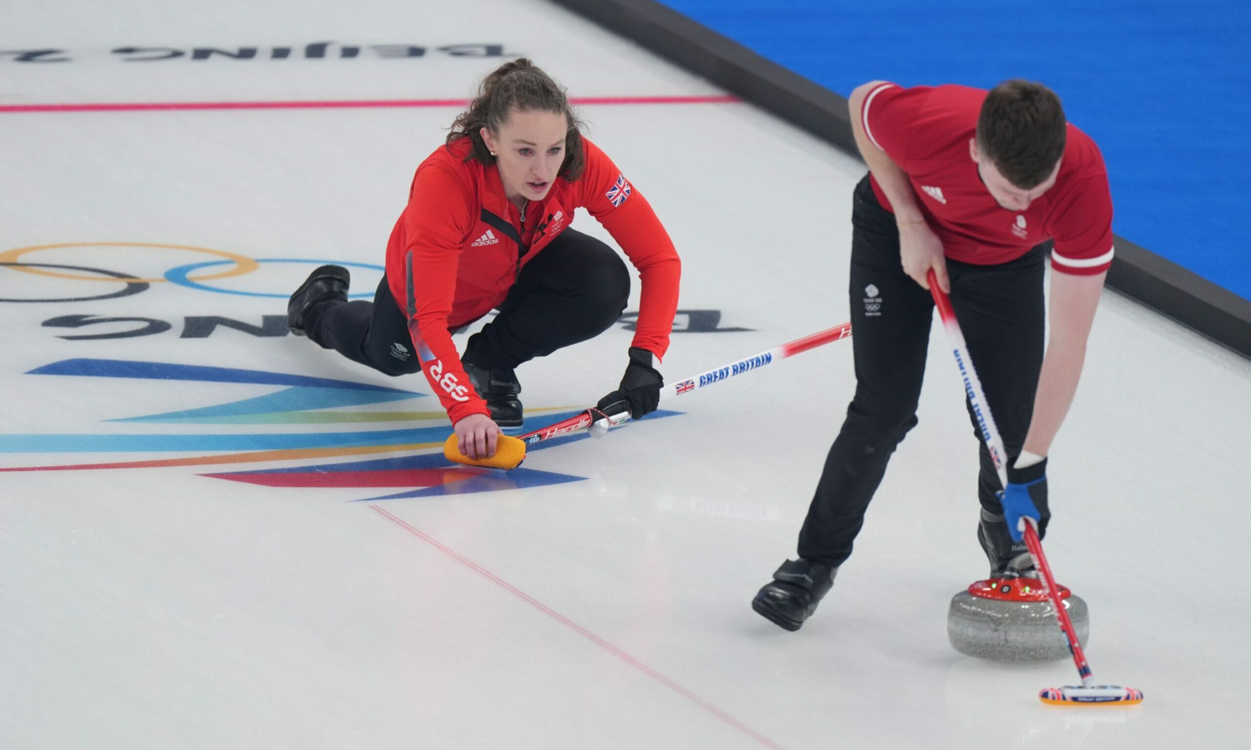 Jennifer Dodds (L) and Bruce Mouat of Britain compete against Canada during the curling mixed doubles round robin session of the Beijing 2022 Winter Olympics.