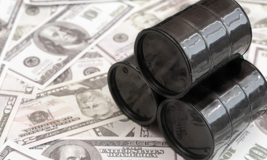 Barrels of oil against the background of American dollars.