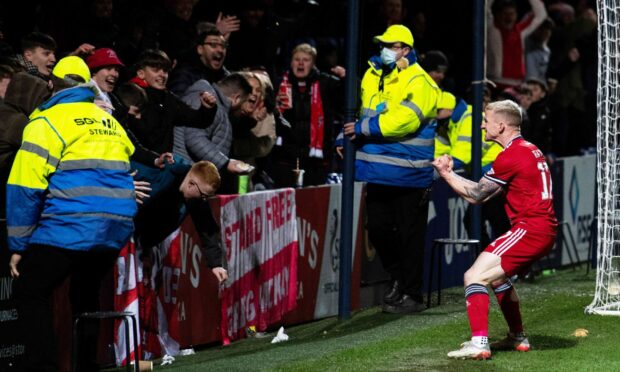 Jonny Hayes celebrates after making it 1-0 against Ross County in Dingwall.