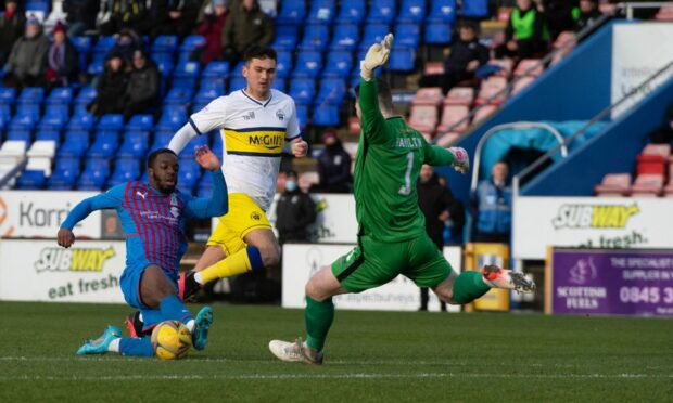 Greenock Morton's Jack Hamilton races out to clear the ball.