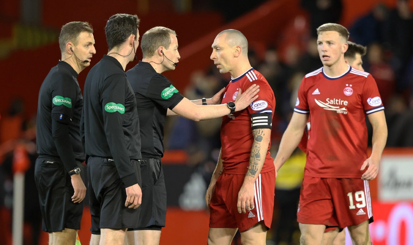 Aberdeen's players speak to referee Willie Collum at full-time after the 3-2 loss to Celtic in February.
