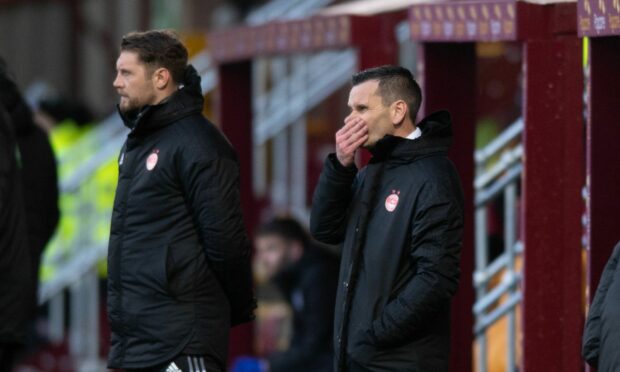 Stephen Glass, centre, and coach Allan Russell have been dismissed by the Dons.