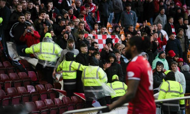 Aberdeen fans vent their frustrations as the players walk past at full time against Motherwell.