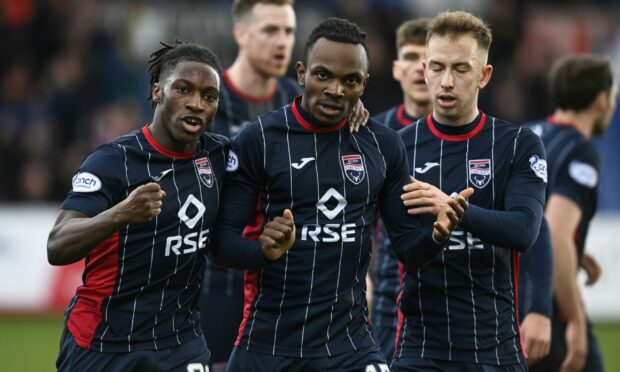 Regan Charles-Cook celebrates with Joseph Hungbo (left) and Harry Paton.