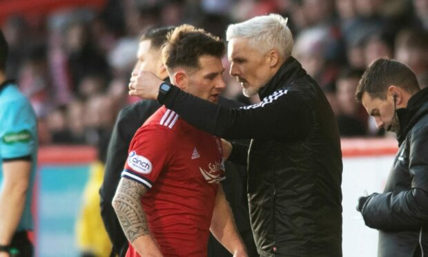 Matty Kennedy is congratulated on his display by manager Jim Goodwin