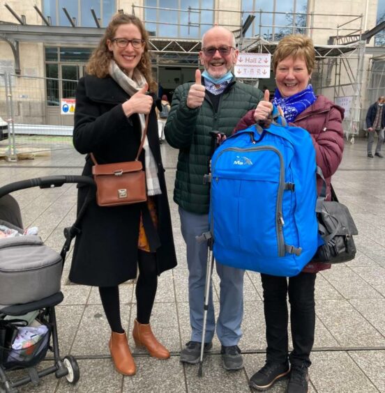 Delphine Prevost, pictured left, reuniting Colin Macaulay and Anne Macaulay with the stolen rucksack in Toulouse.