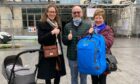 Delphine Prevost, pictured left, reuniting Colin Macaulay and Anne Macaulay with the stolen rucksack in Toulouse.