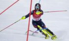 Charlie Guest, of Britain passes a gate during the second run of the women's slalom at the 2022 Winter Olympics.