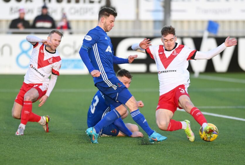 Cove Rangers skipper Mitch Megginson with Airdrieonians pair Scott Agnew and Brody Paterson