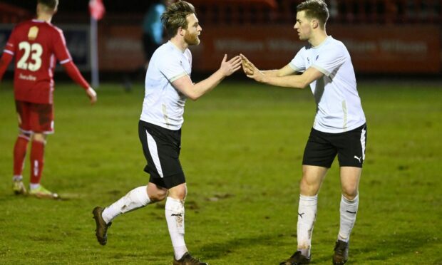Brora Rangers' Dale Gillespie, left, celebrates after scoring the opening goal.