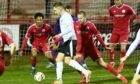 Brora's Mark Nicolson, centre, tries to get a shot away during their win against Brechin