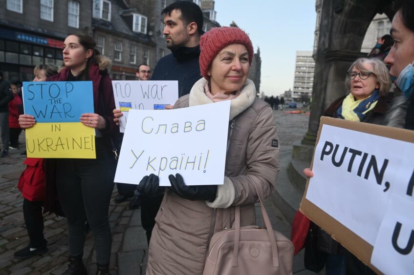 Image of Ukrainian women holding anti war signs at a recent protest in Aberdeen.