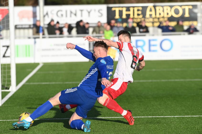 Rory McAllister turns the ball across goal for Cove
