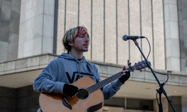 David Angus busking outside Marks and Spenser in Aberdeen. Photo by Adrian Thomson
