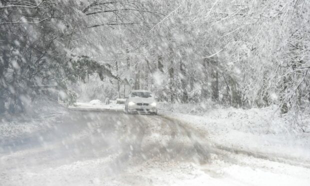 A car battling heavy snowfall. Picture by DCT Media.