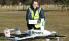 Skyport flight operations manager Alastair Skitmore places the medicine box in the drone.