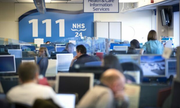 An NHS 24 call centre with people answering the 111 phone lines.