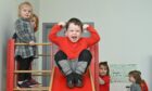 Kids from the Turriff Playgroup playing on a slide in their new playroom at Turriff Primary School
