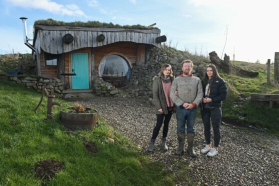 The owners of a glamping site near Turriff have been threatened to stop calling their huts "Hobbit huts". Team member Laura Crockatt,owner Jamie Menzies and daughter and team member Millie Menzies.
Picture by Jason Hedges.