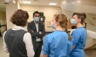 Humza Yousaf speaks to medical staff in Aberdeen. Picture by Kenny Elrick.