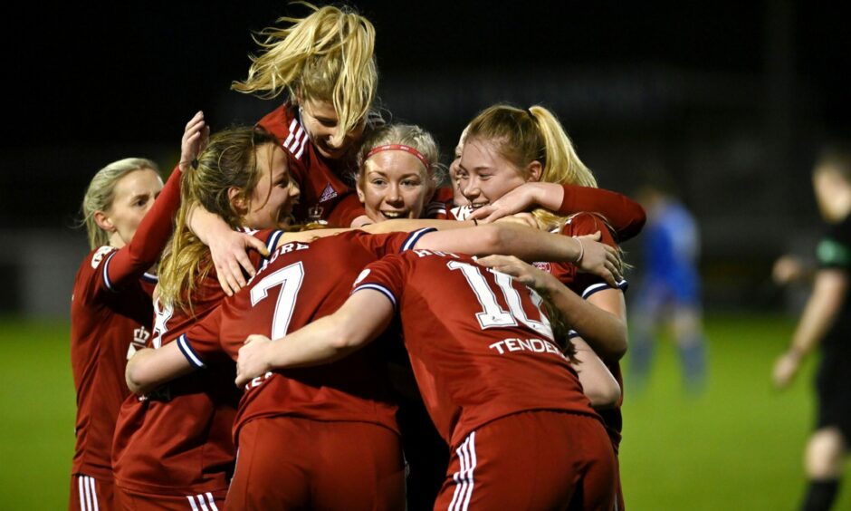 The Aberdeen Women's team huddled together to celebrate