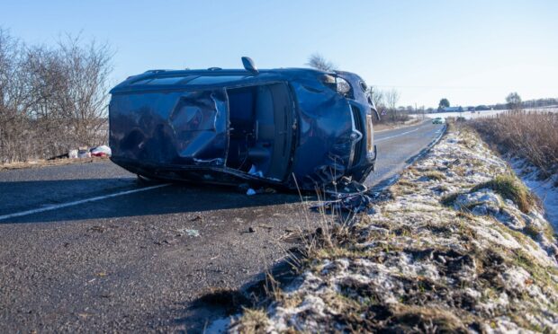 The one vehicle crash left the car on its side blocking the road on the A947 between Newmachar and Dyce. 
Picture by Kath Flannery.