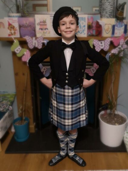 Lachlan Daguid at home in his full Highland dancing attire