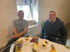 2 men smiling in a care home