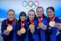 Great Britain's Mili Smith, Hailey Duff, Jennifer Dodds, Vicky Wright and Eve Muirhead celebrate with their gold medals after beating Japan in the Winter Olympic final in Beijing. Image: Andrew Milligan/PA Wire