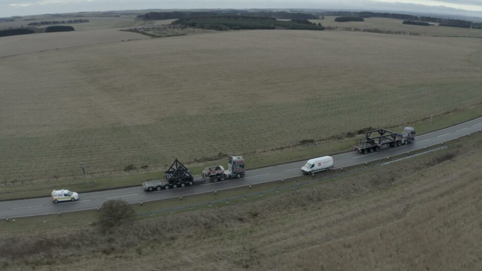Drone photo of Orbex rocket launcher convoy in countryside. 