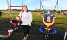Shannon Button, spokesperon for Ellon Parks Improvement Committee, with local children at the newly installed swings and the all-inclusive swing at Auchterellon Park in Ellon. Picture by Paul Glendell.